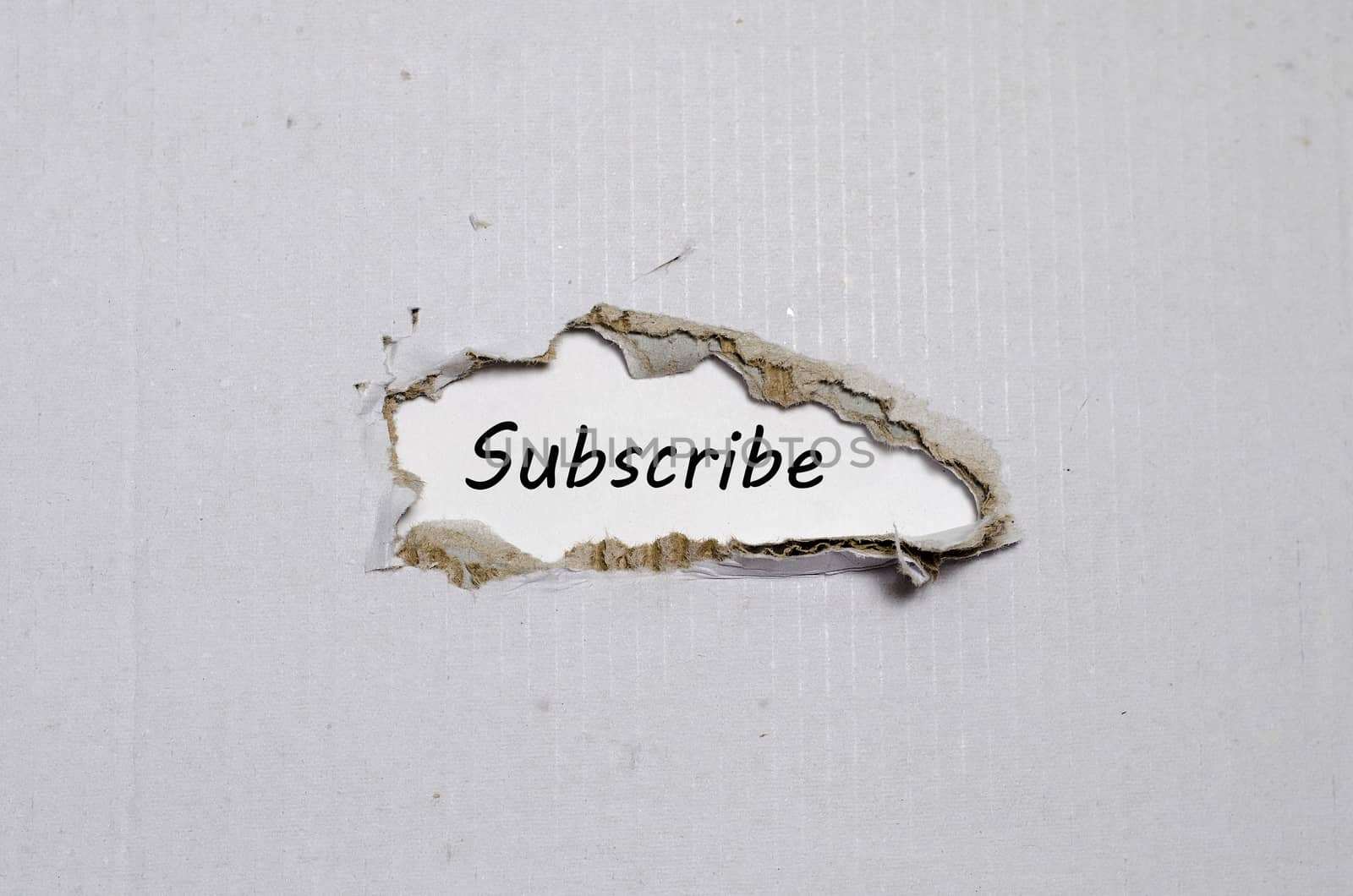 The word subscribe appearing behind torn paper