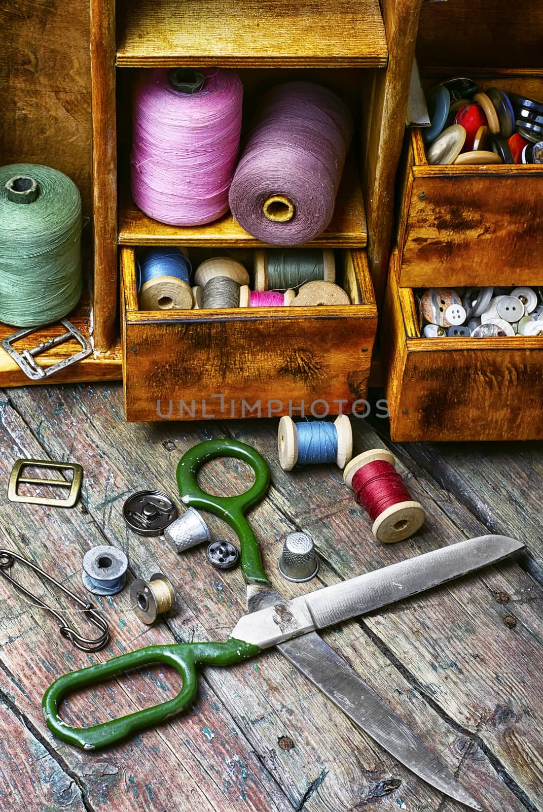 Spools of sewing threads and buttons from clothing