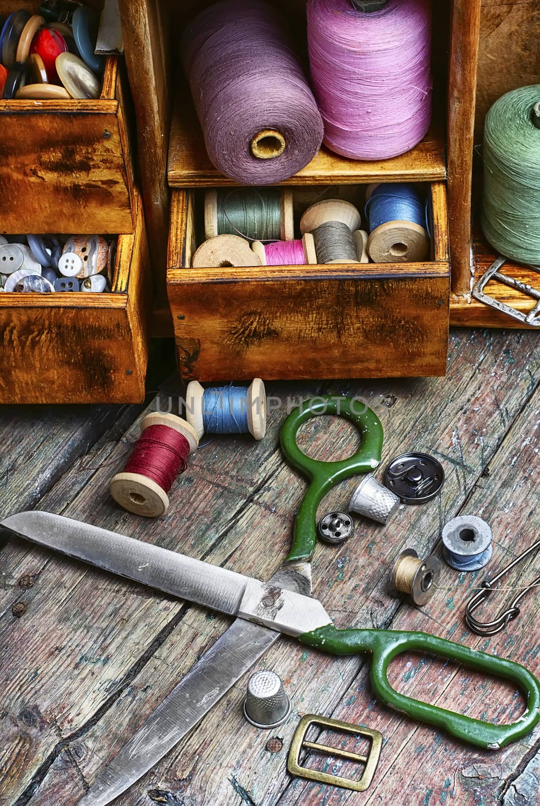 Spools of sewing threads and buttons from clothing