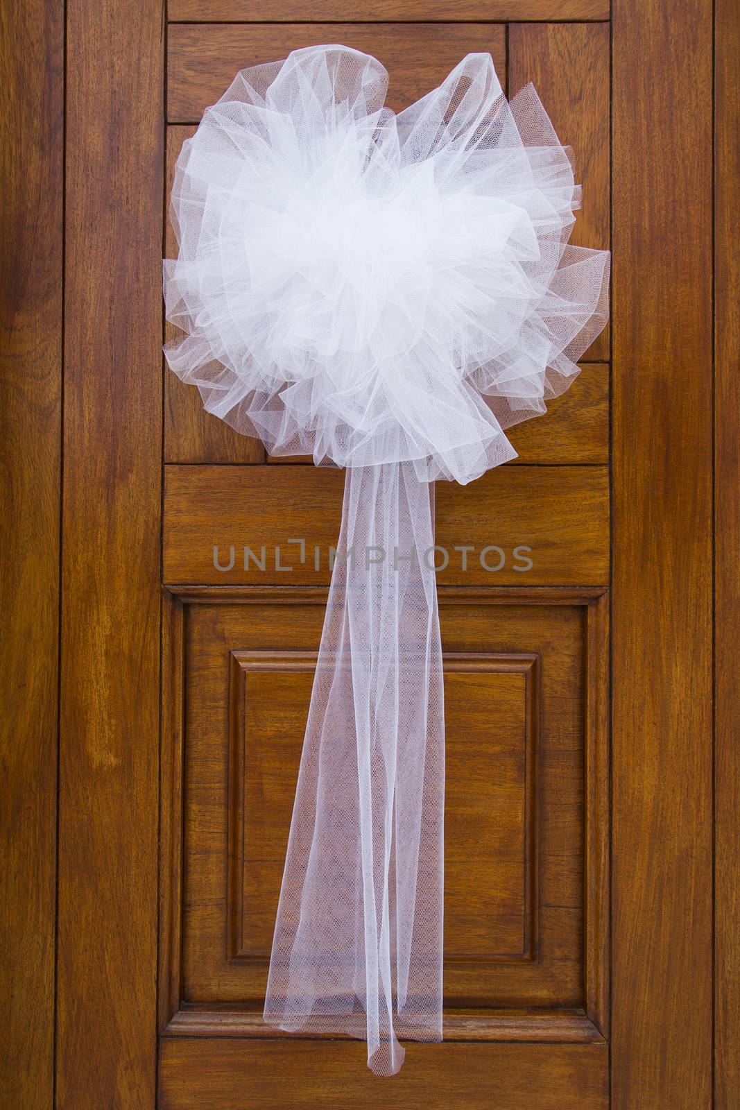 View of a bridal bow put on the front door of the bride