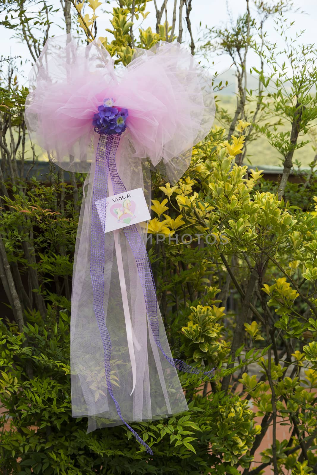 View a pink ribbon as a decoration for a baptism