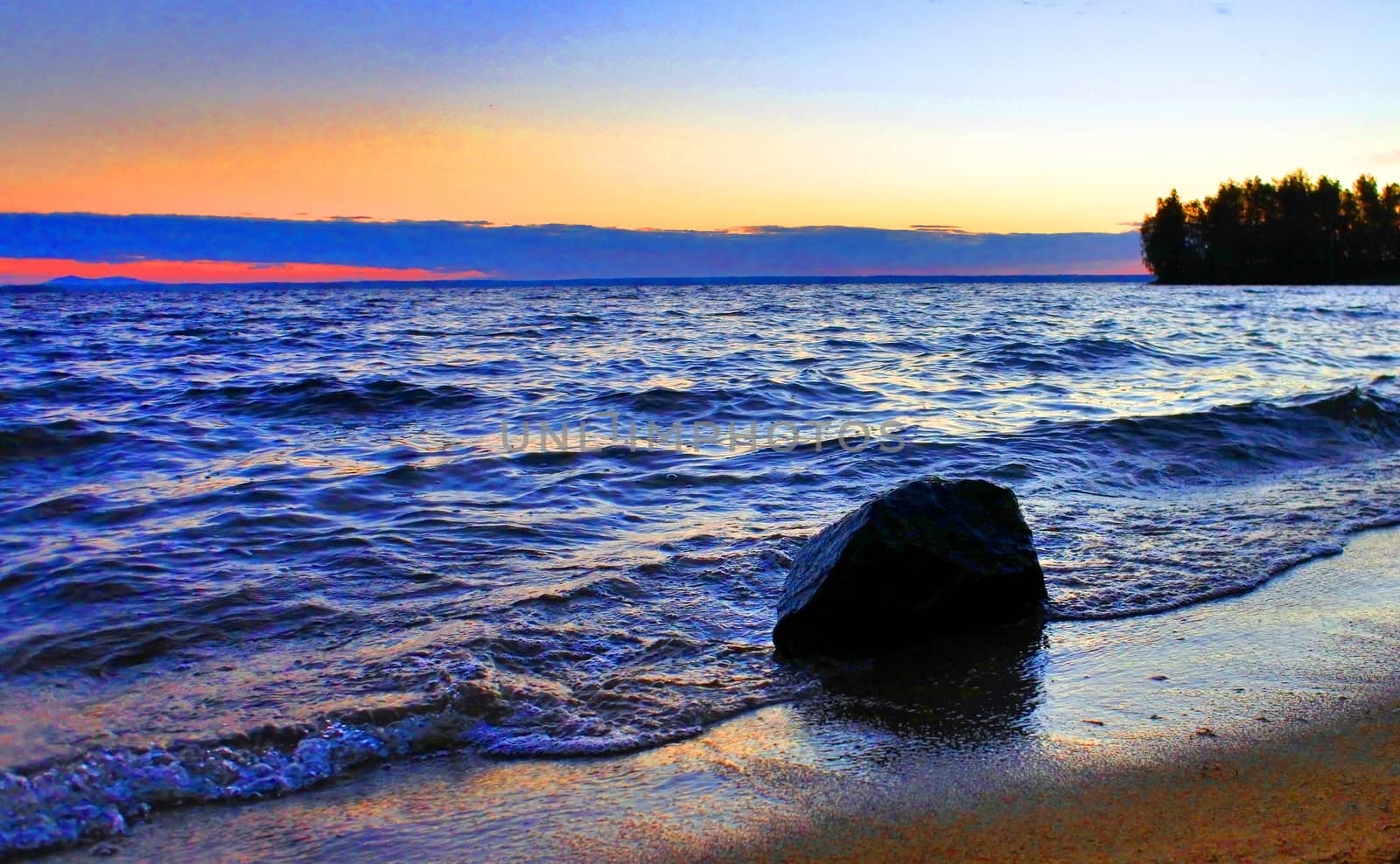 Beautiful sunrise on the lake in windy weather