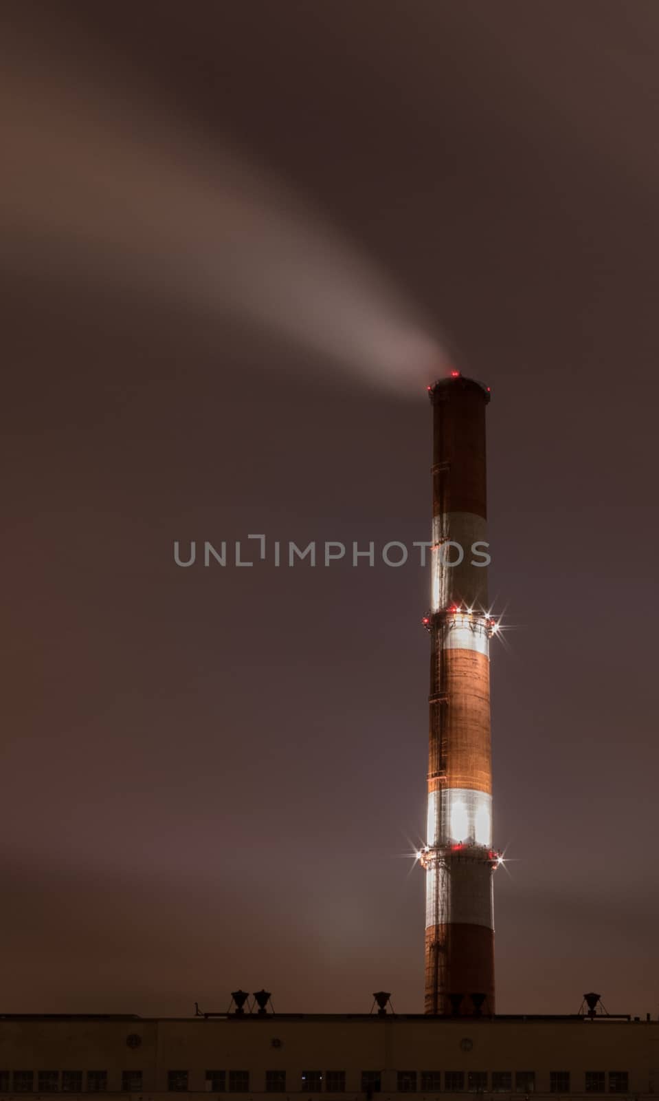 Smoke stack against sky at night by dpetrakov