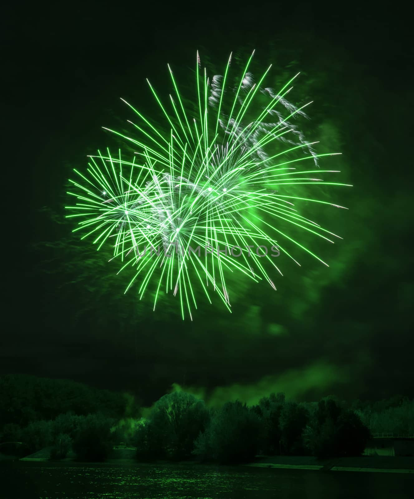 Beautiful green fireworks at night on the river in Moscow by dpetrakov