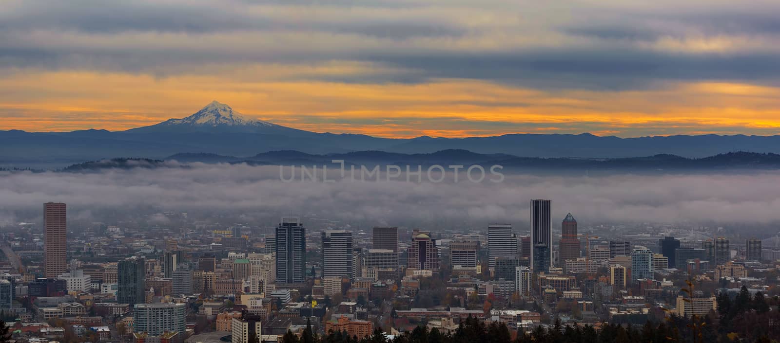 Foggy Portland Oregon downtown cityscape and Mount Hood during sunrise panorama