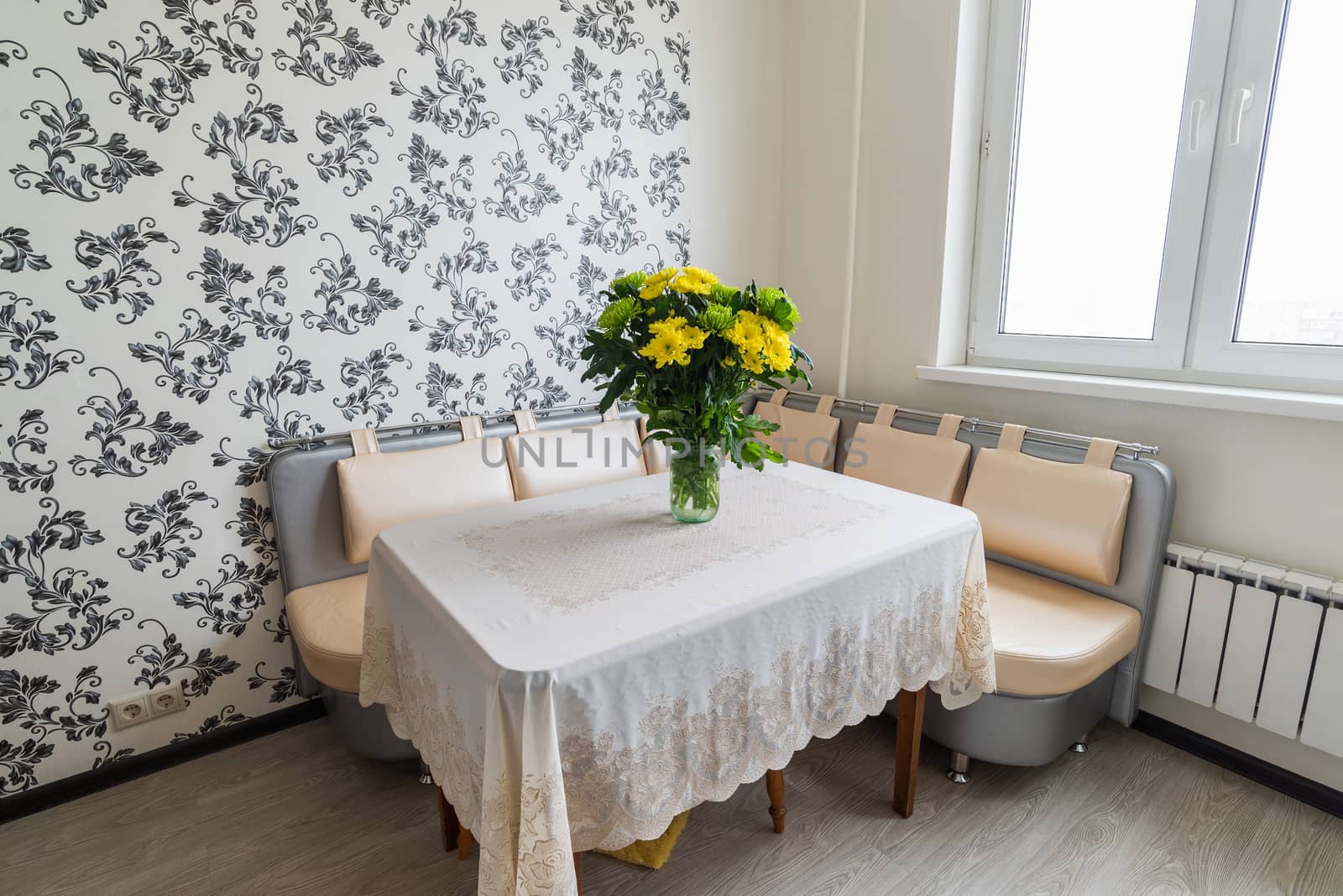 Bouquet of yellow and green chrysanthemums standing on the kitchen table