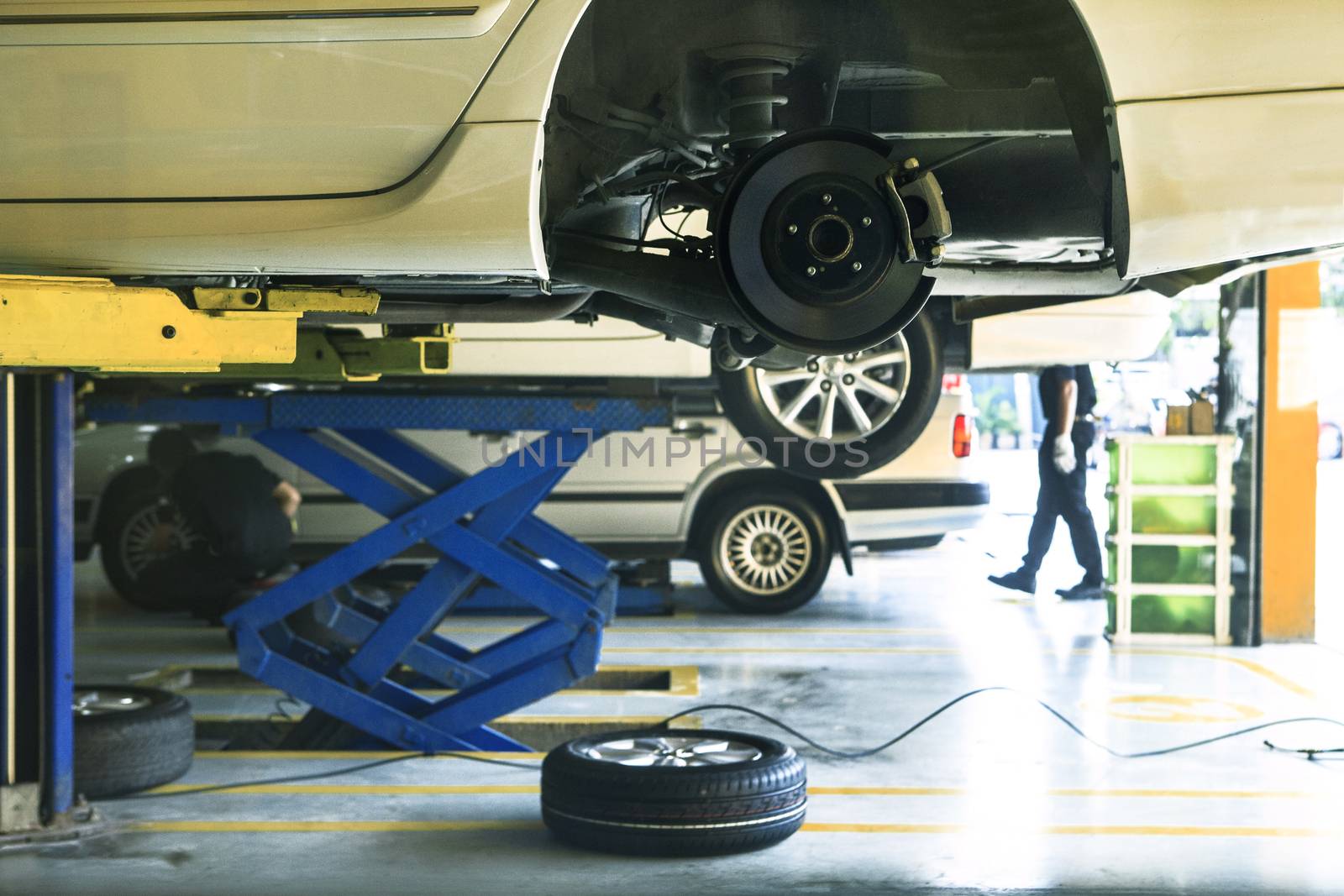  car wheel  suspension and brake system maintenance in auto service before long journey