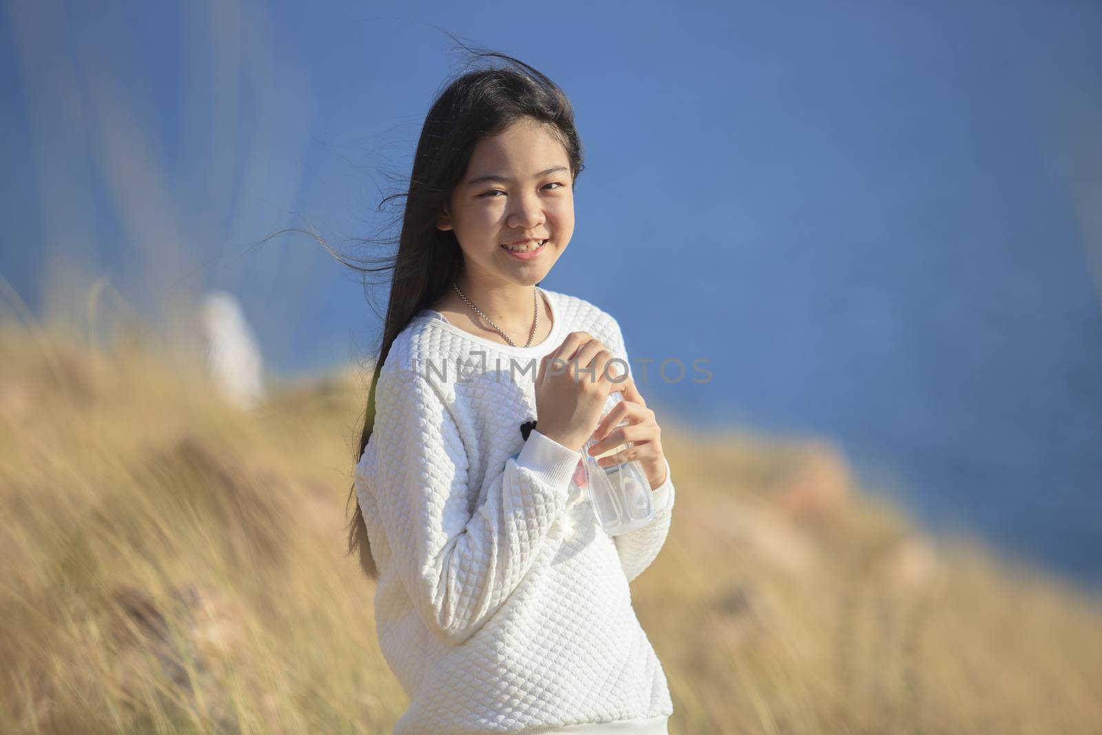 portrait toothy smiling face of asian girl relaxing emotion outd by khunaspix