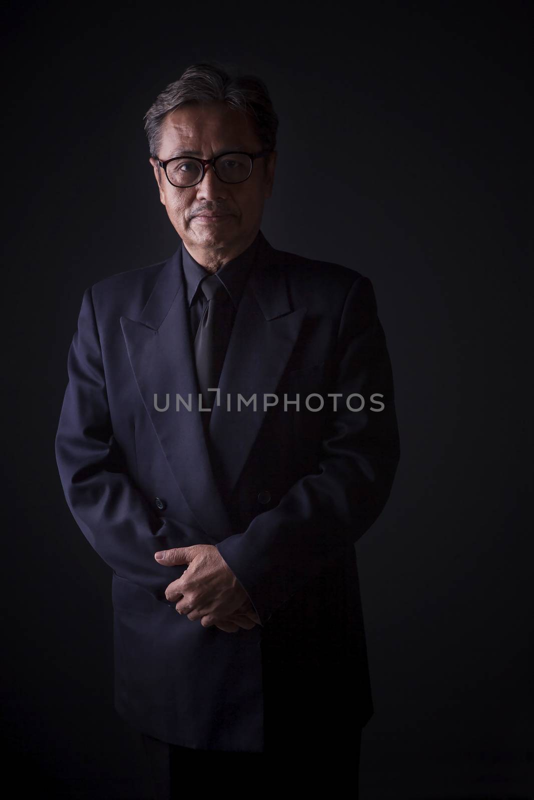 thai senior man wearing black suit sadness emotion ,portrait by  by khunaspix