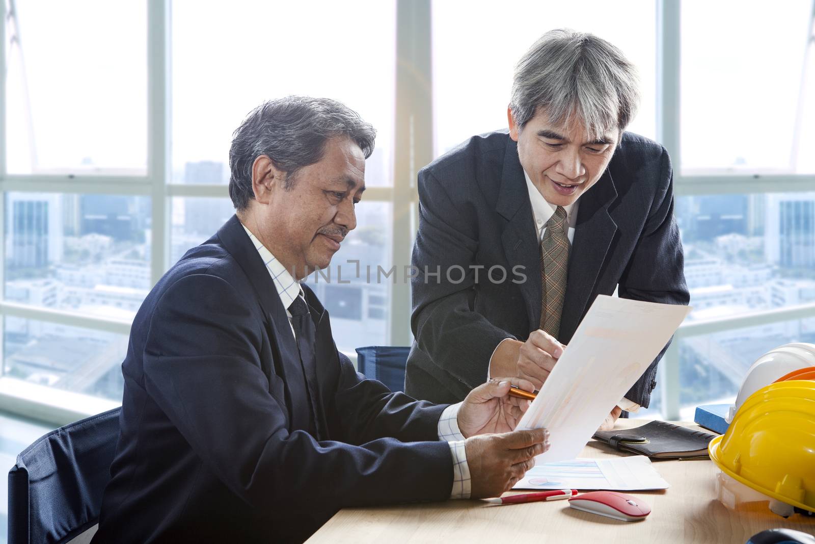 partner of senior engineering working man serious meeting about  by khunaspix