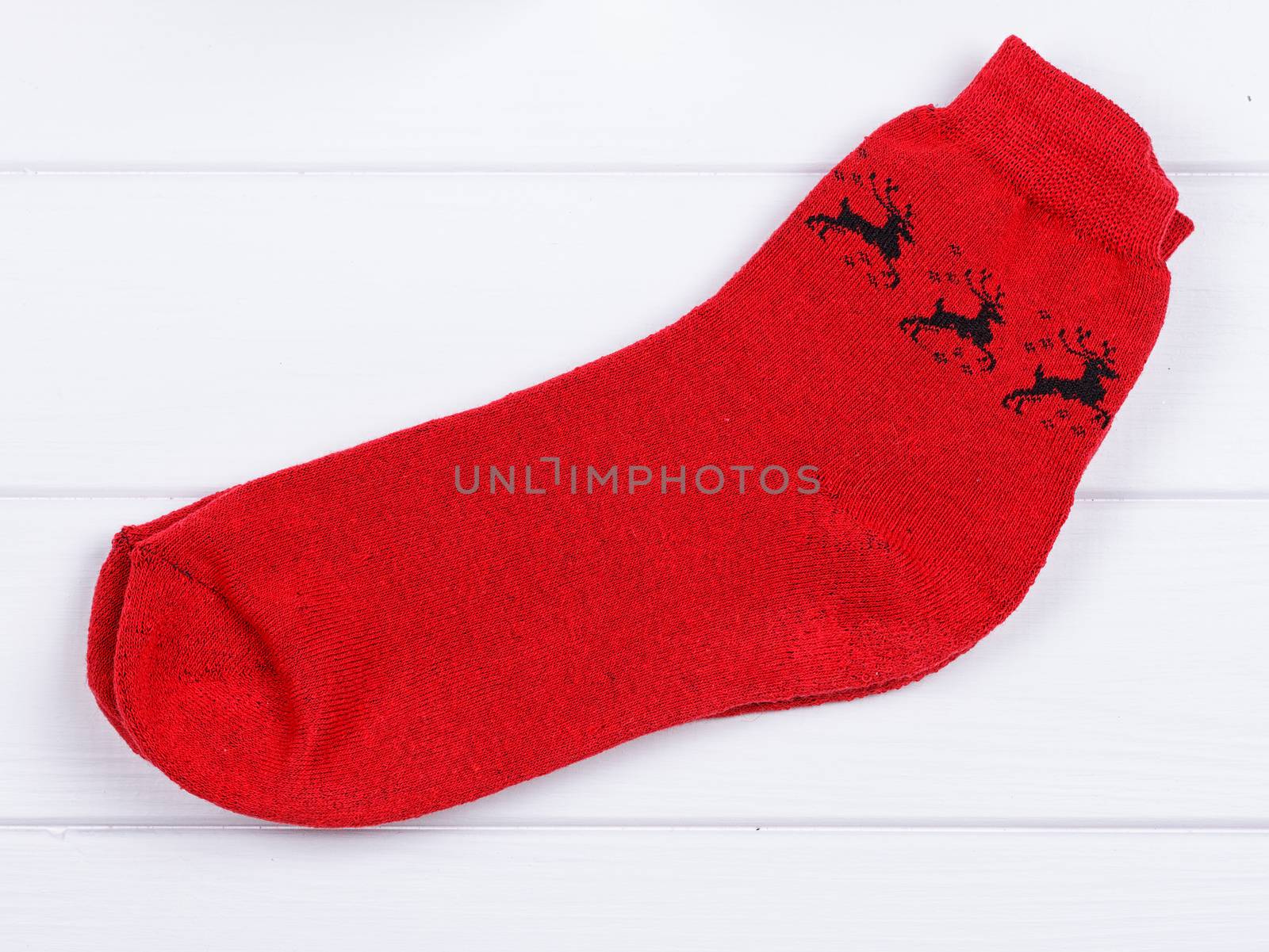 Christmas red socks on a white wooden background