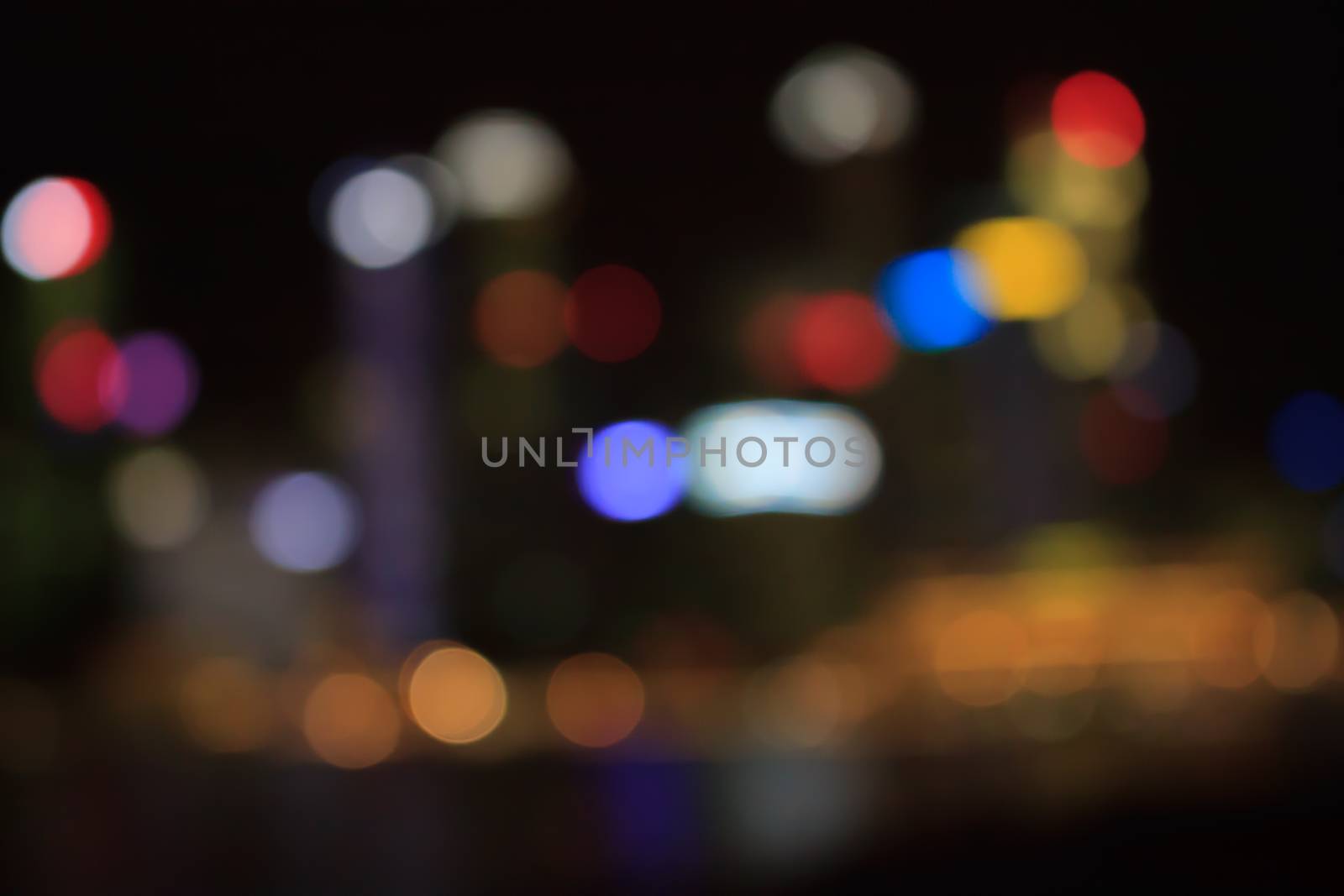 Colorful bokeh of city in night time by worrayuth