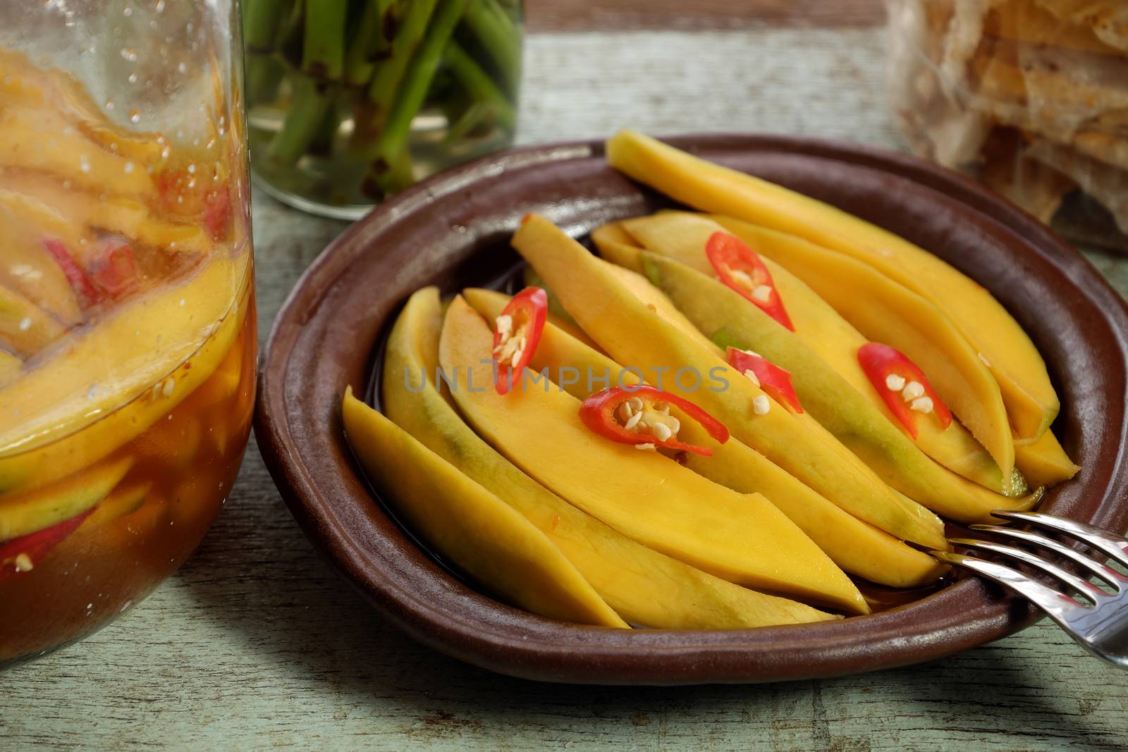 Vietnamese fruit, green mango cut in slice, a popular tropical fruit, rich vitamin A, vitamin C, collagen, good for health and impulse calcium absorption