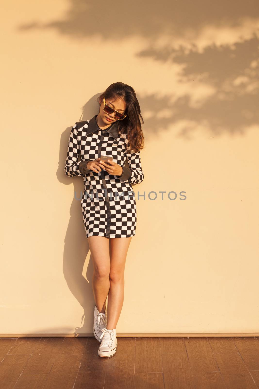 young and beautiful hipster woman wearing sun glasses and readin by khunaspix