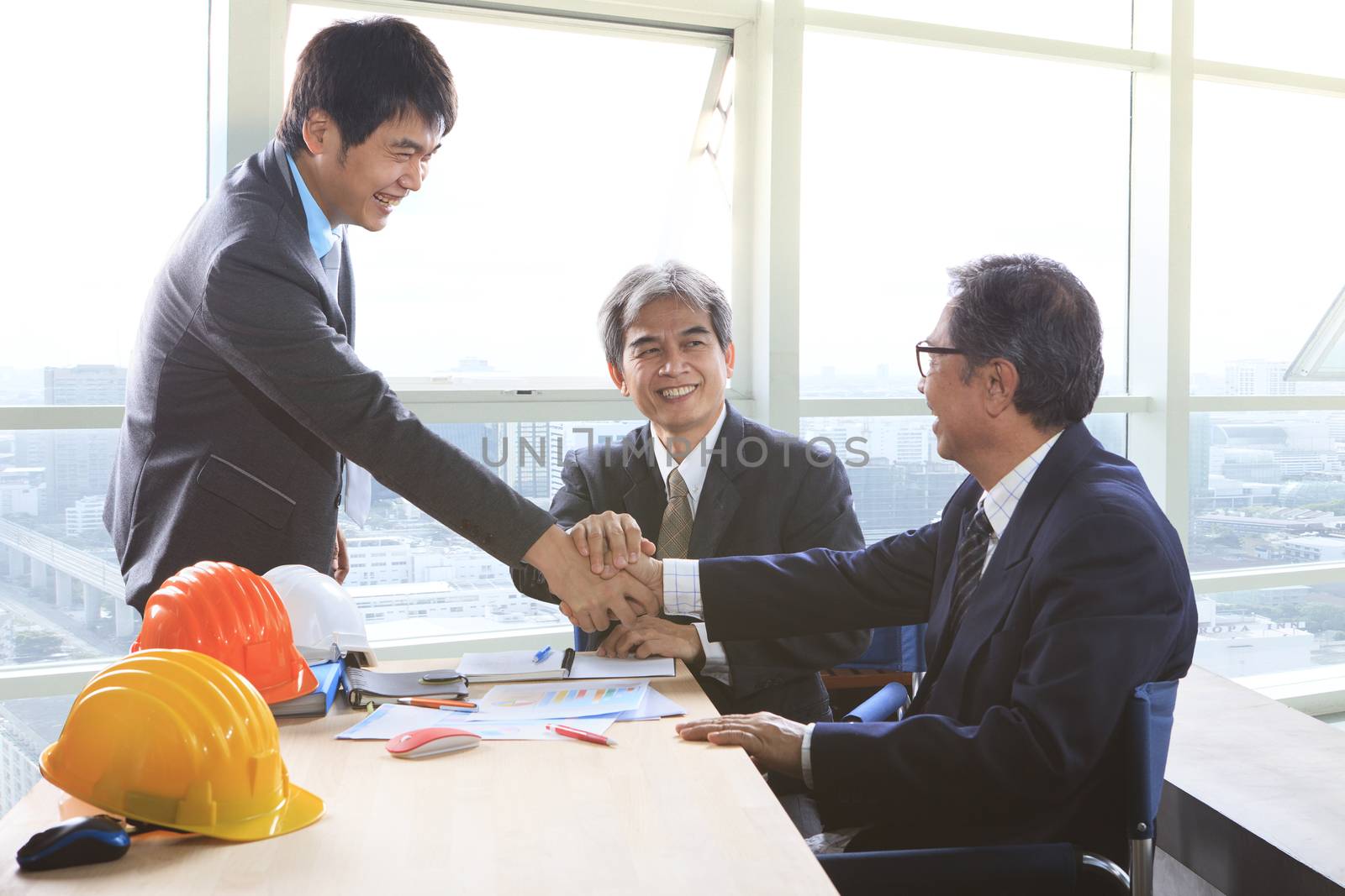 business man shaking hand after successful project solution plan by khunaspix