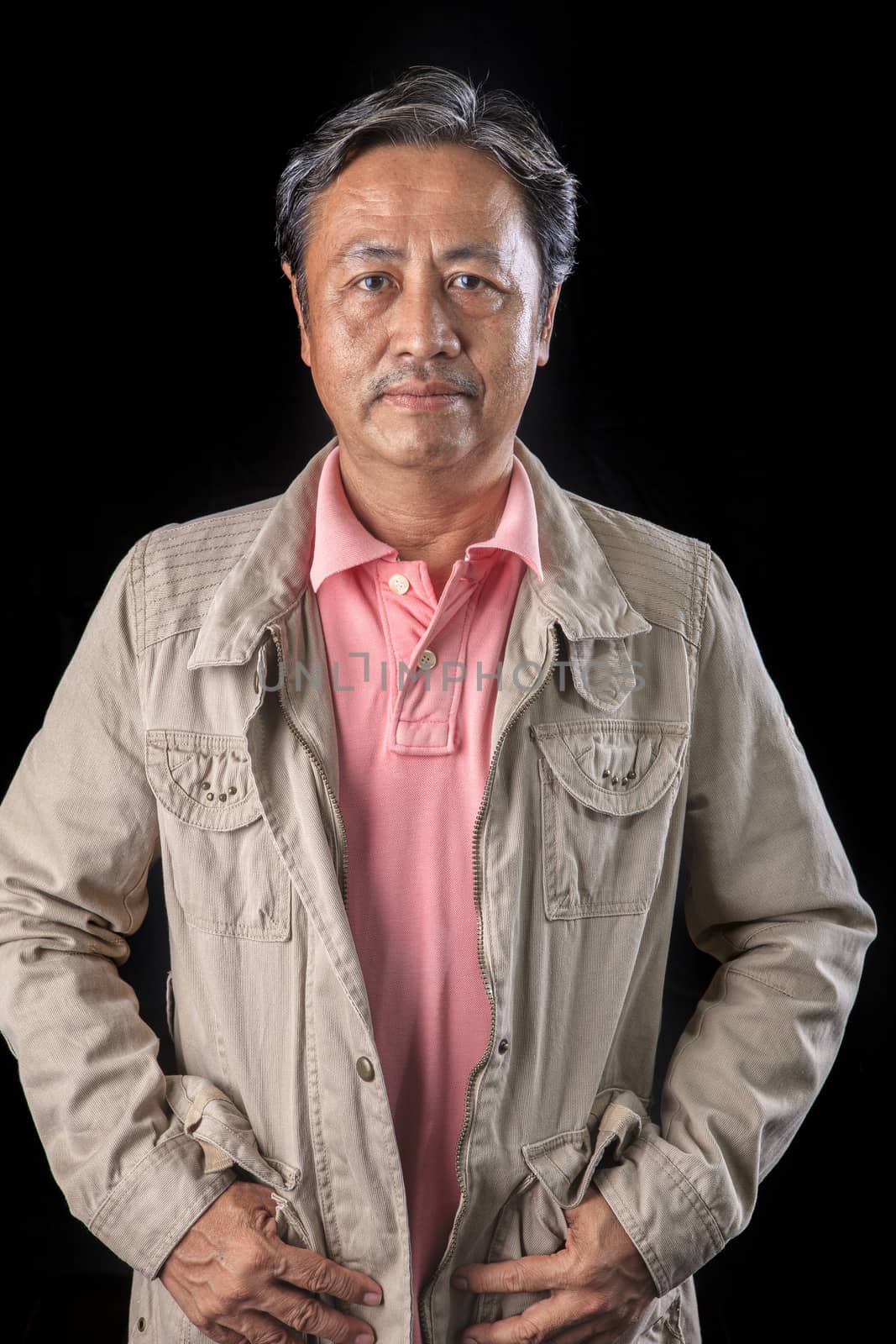 portrait close up smiling happiness face of 59s years old asian man with studio light against black background