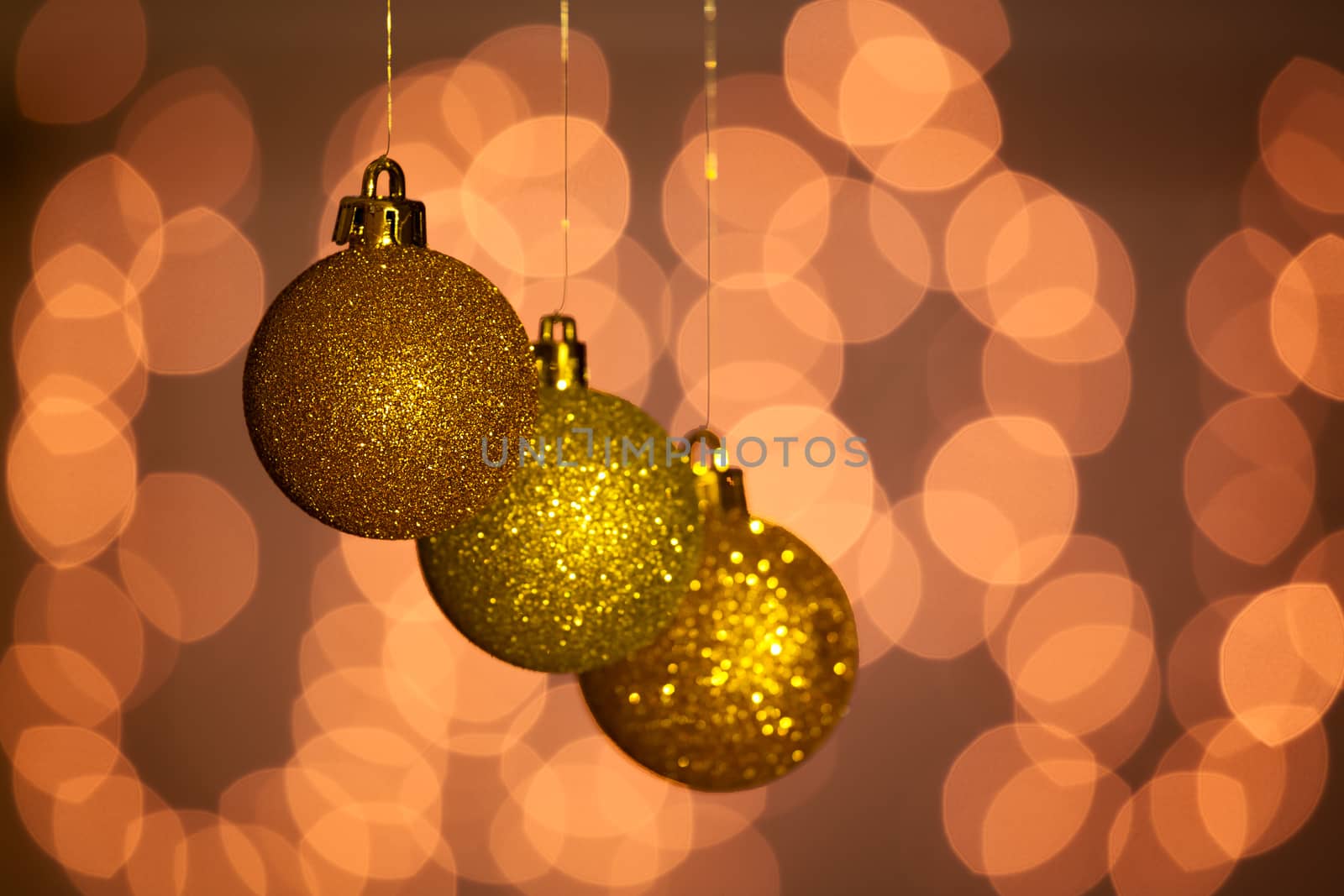 Christmas golden balls with lights on background