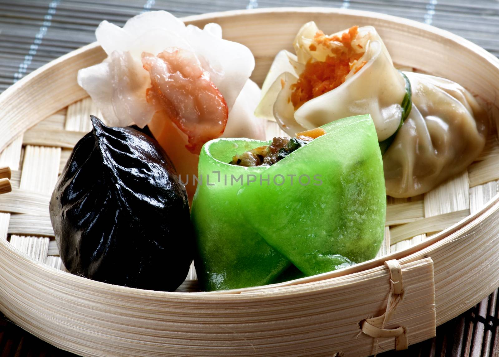 Various Dim Sum in Bamboo Steamed Bow in Shadow closeup on Straw Mat background