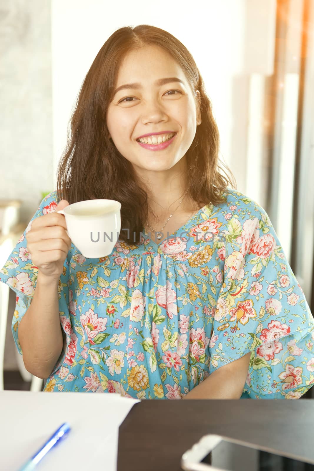 asian woman smiling face happiness emotion and hot beverage cup in hand relaxing at home
