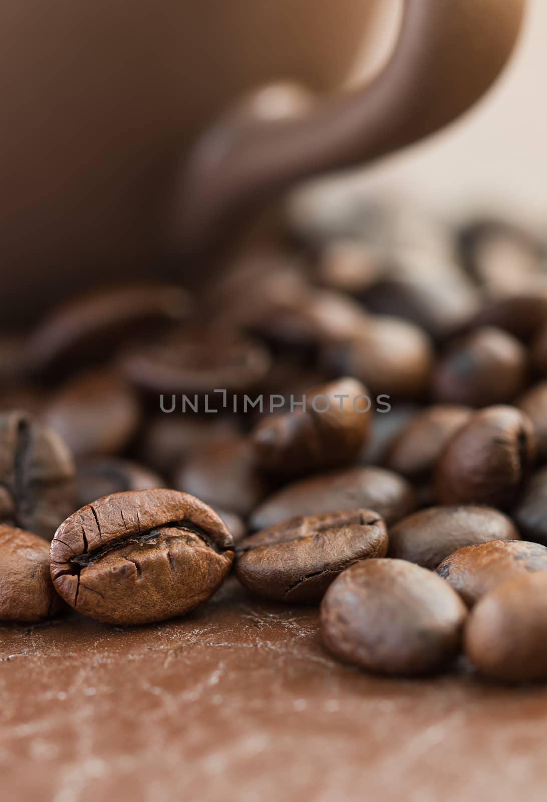 Close up roasted coffee beans and coffee cup