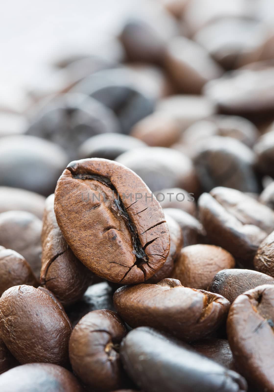 Close up heap of roasted brown coffee beans