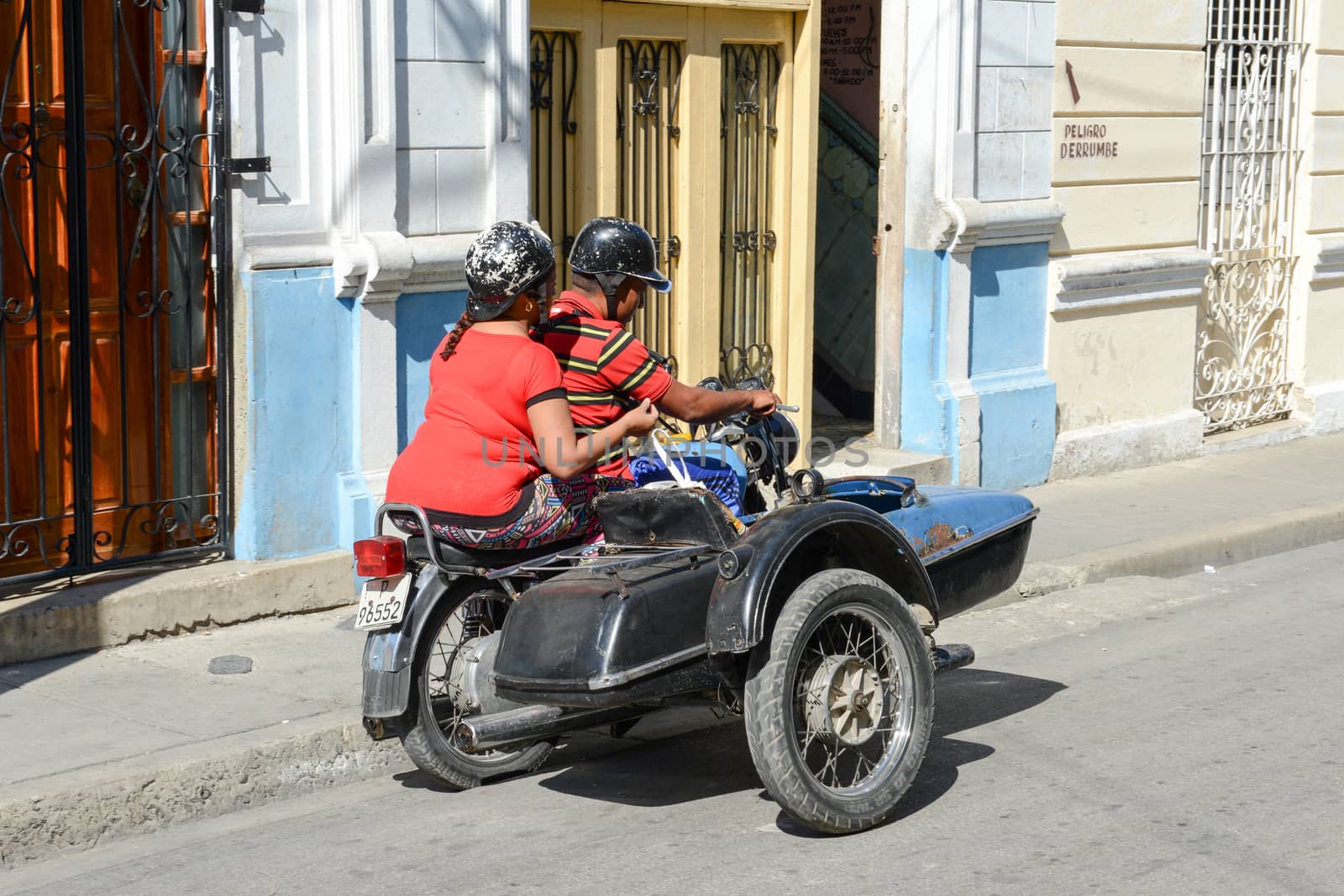 Santiago de Cuba, Cuba - 14 january 2016: people driving a sidecar bike at Santiago de Cuba, Cuba