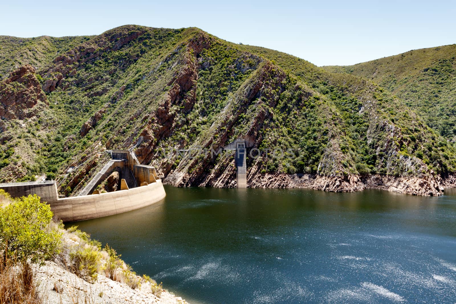 The Kouga Dam is an arch dam on the Kouga River about 21 km west of Patensie in Kouga Local Municipality, South Africa.