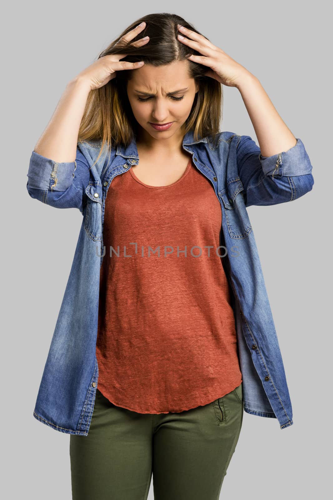 Beautiful woman with hands on head worried with something