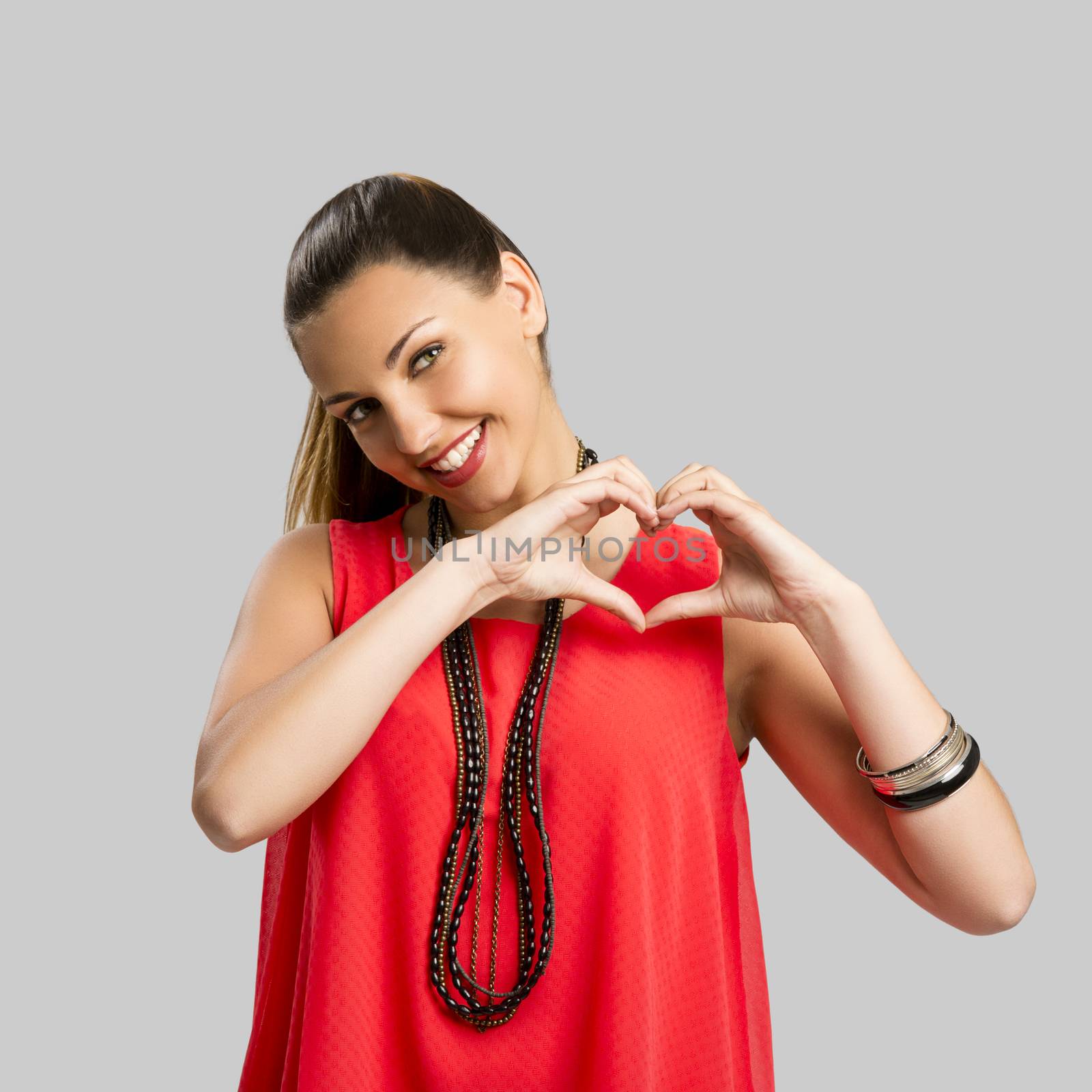 Portrait of a beautiful woman making the heart shape with her hands