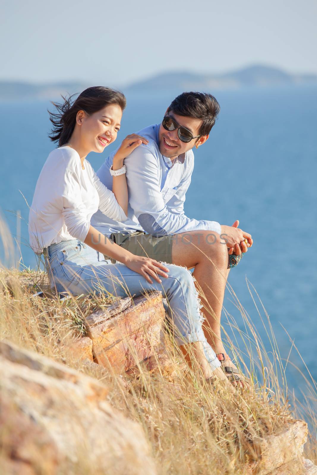 portrait of asian younger man and woman relaxing vacation at sea by khunaspix