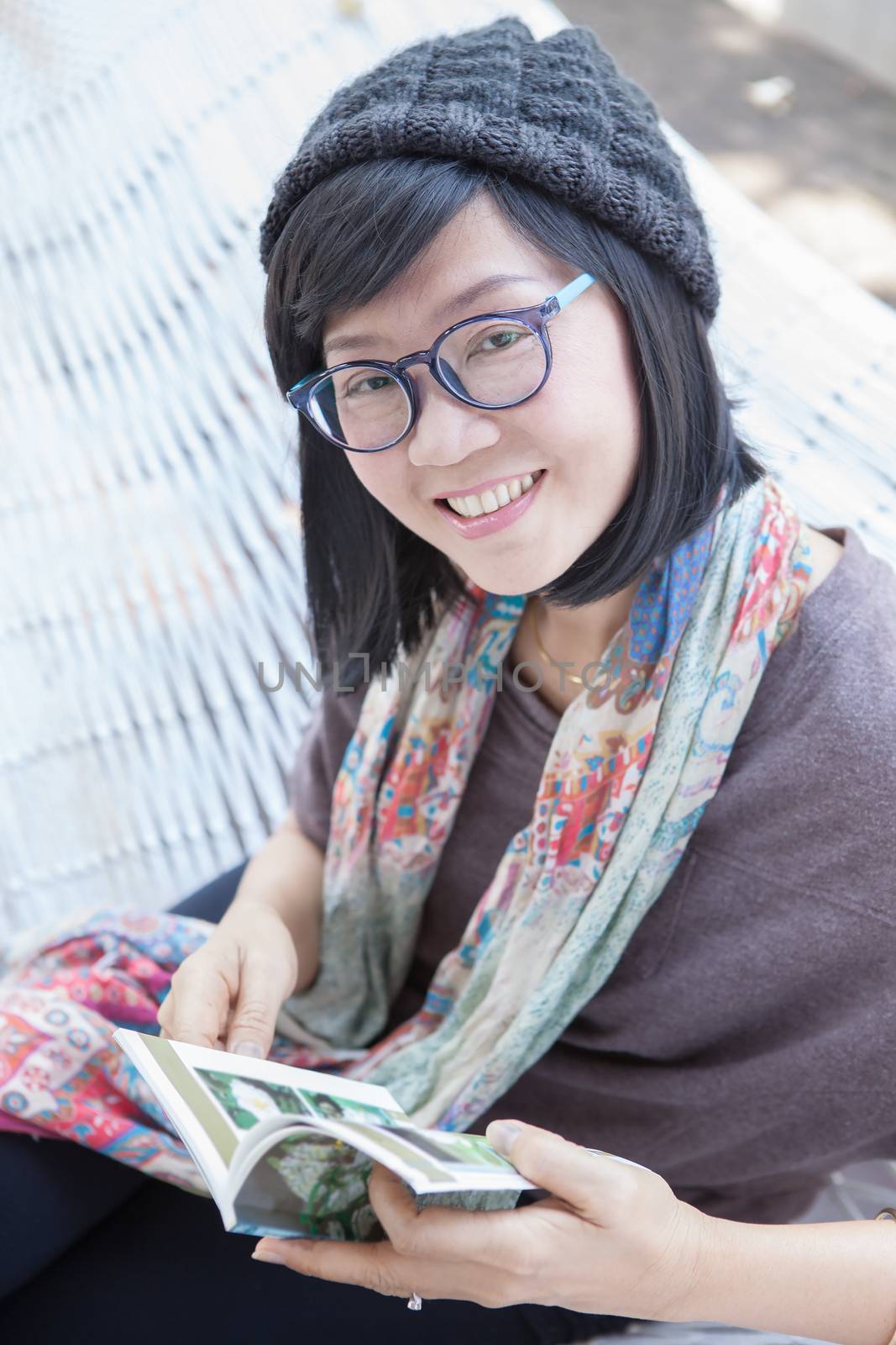 portrait of beautiful asian woman relaxing time reading book on cradle happiness emoton with smiling face