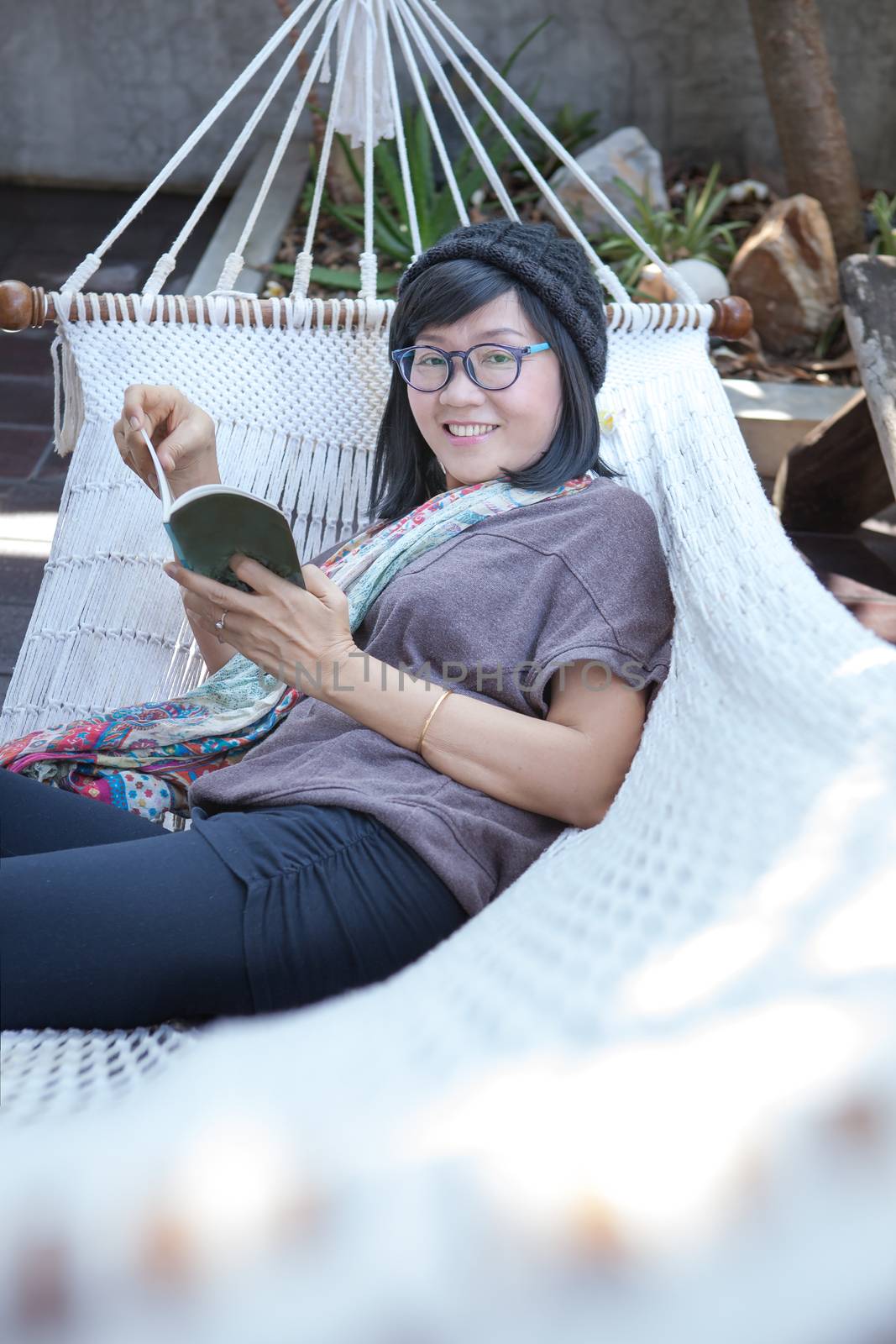 portrait of beautiful asian woman relaxing time reading book on cradle happiness emoton with smiling face