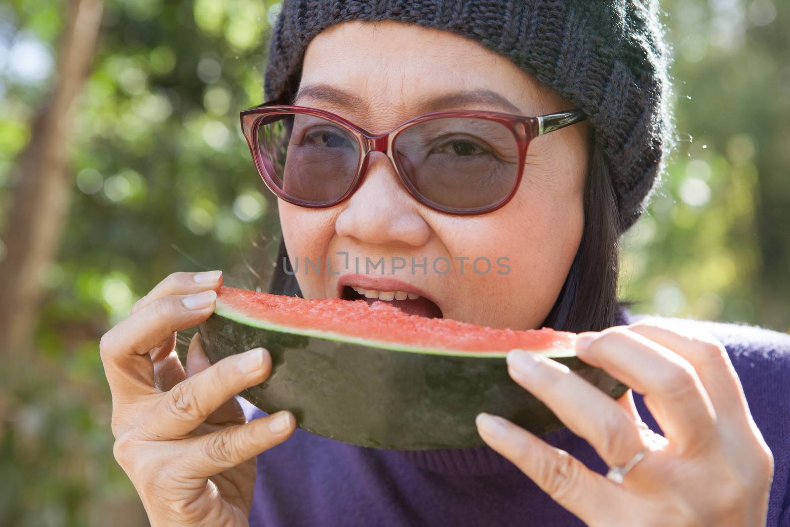 close up face of young woman earting water melon 