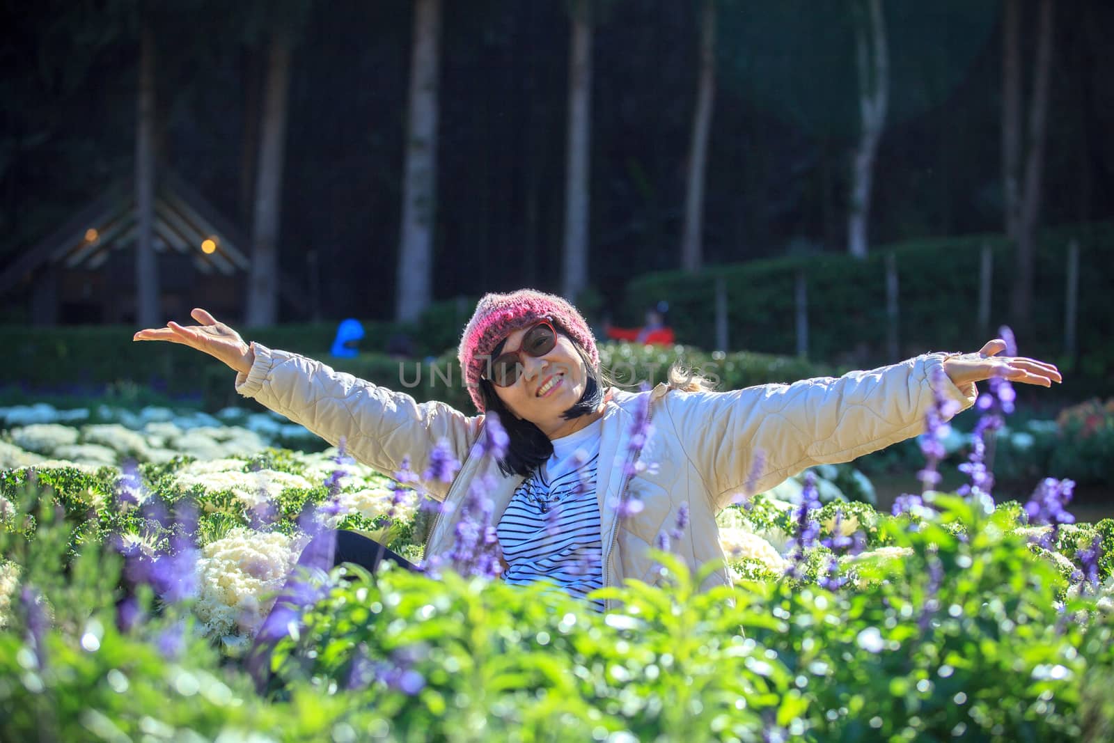 portrait of happiness asian woman with smiling face in blooming flowers garden use for relaxing people in vacation traveling