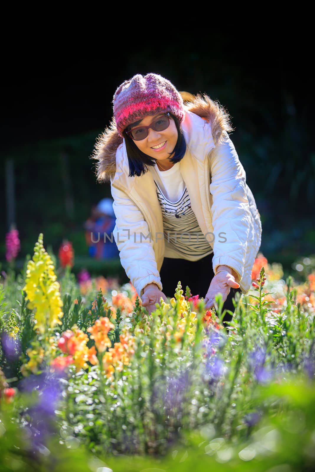 portrait of happiness asian woman with smiling face in blooming flowers garden use for relaxing people in vacation traveling