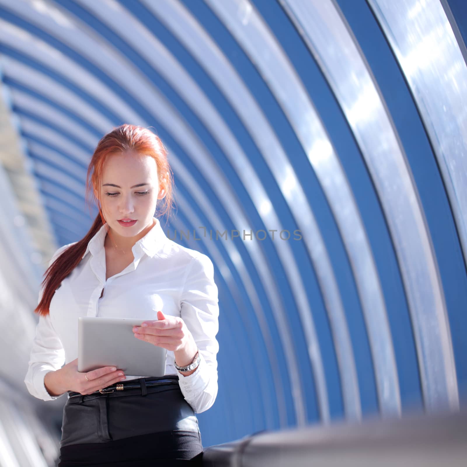 Businesswoman using tablet by ALotOfPeople