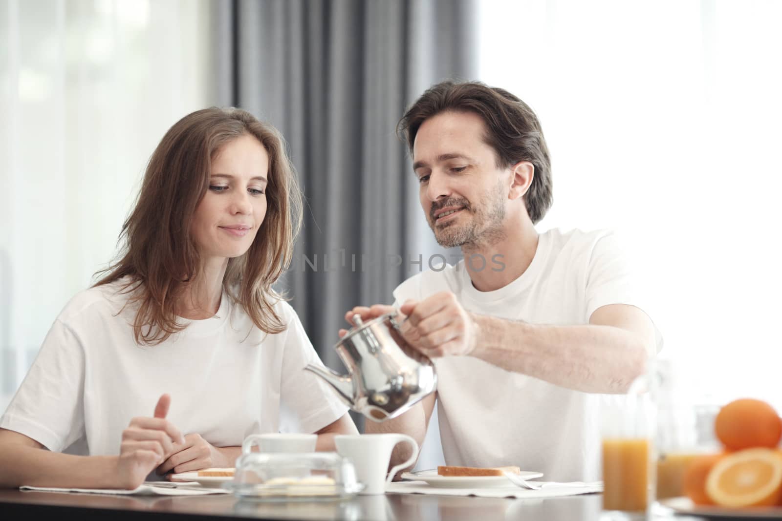 Couple having breakfast together at home 