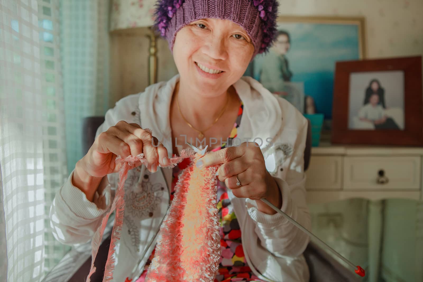 woman with smiling face happiness emotion knitting working at home