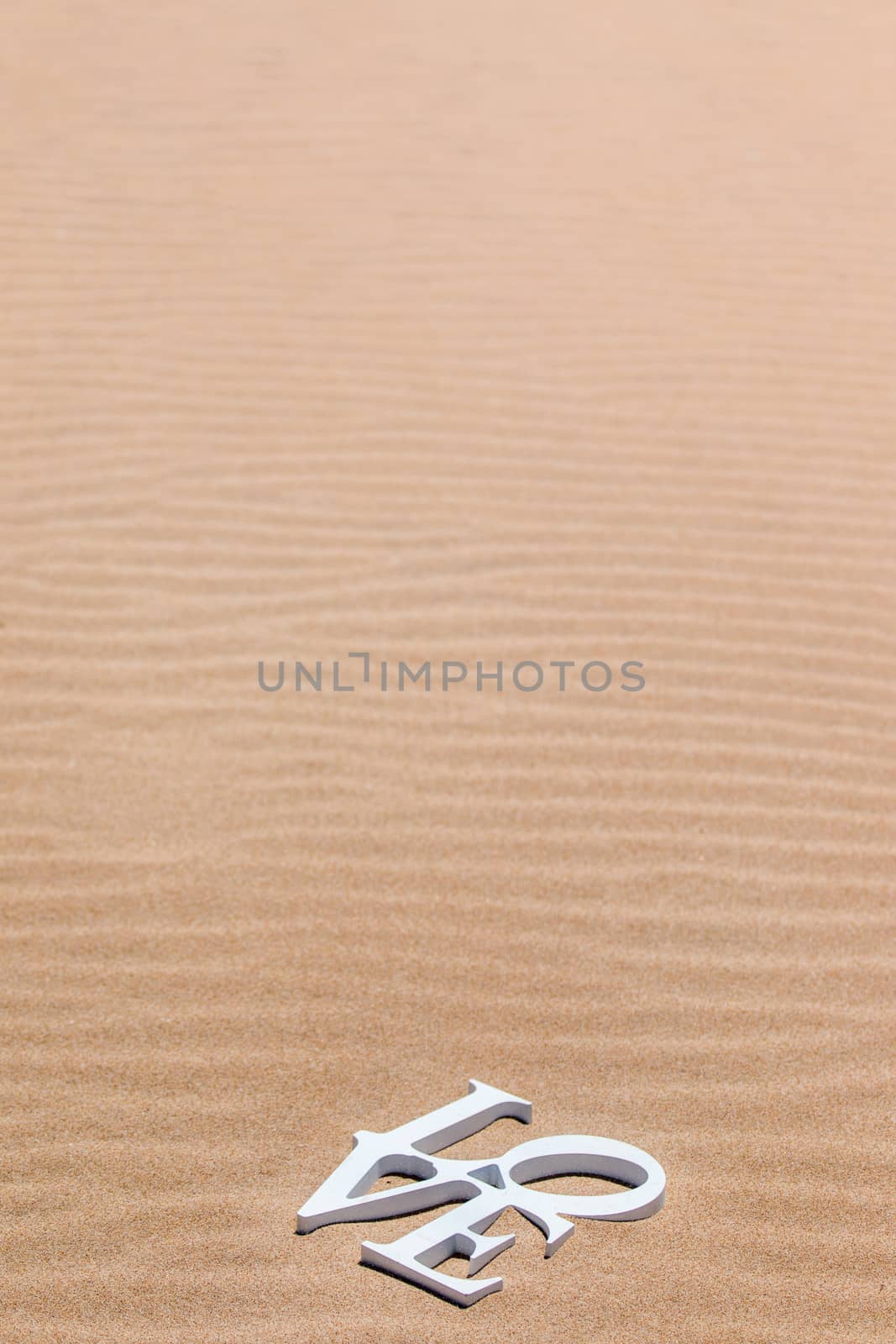 Love words on sand by membio