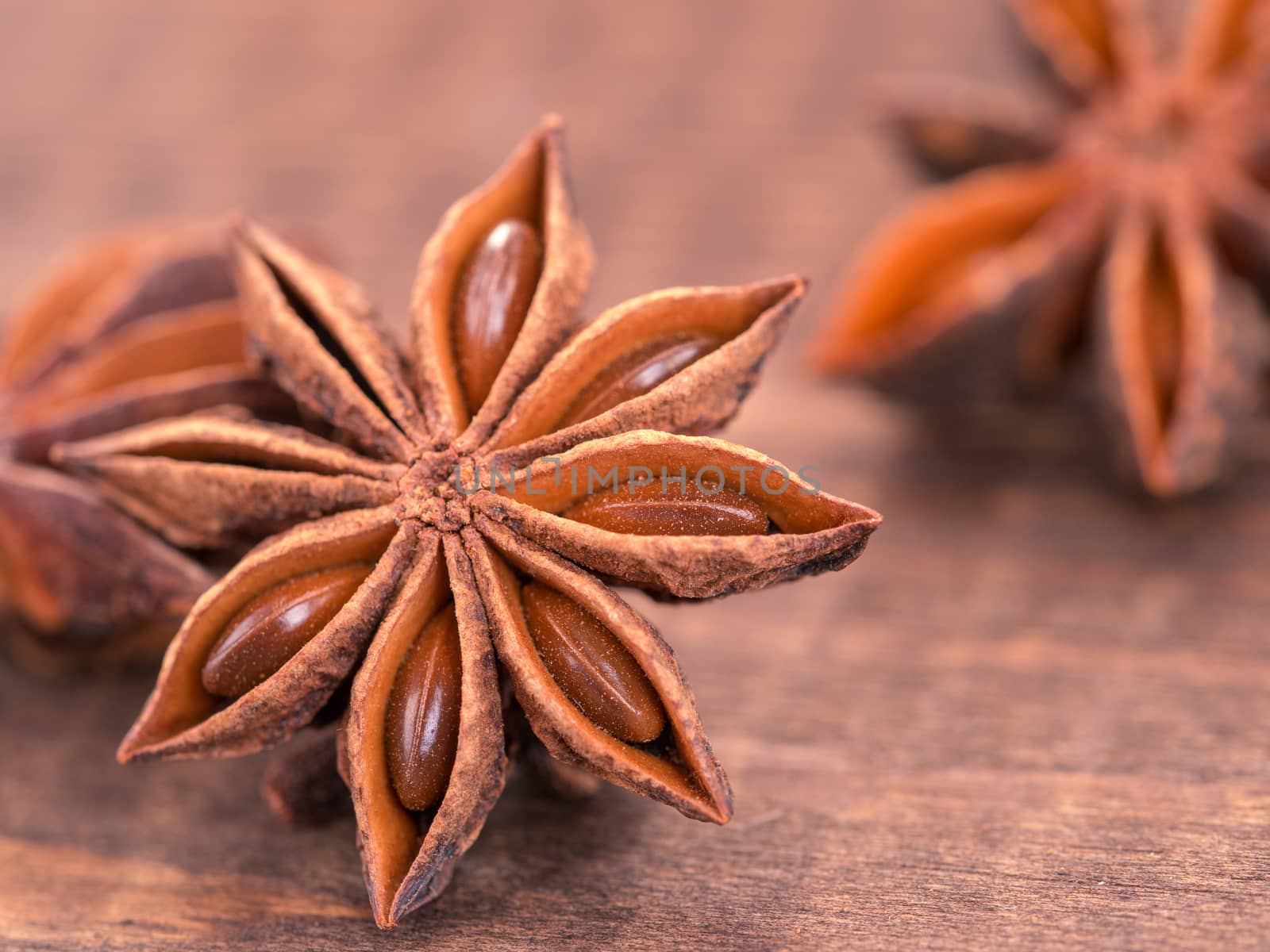 star anise on wooden background close up with copy space