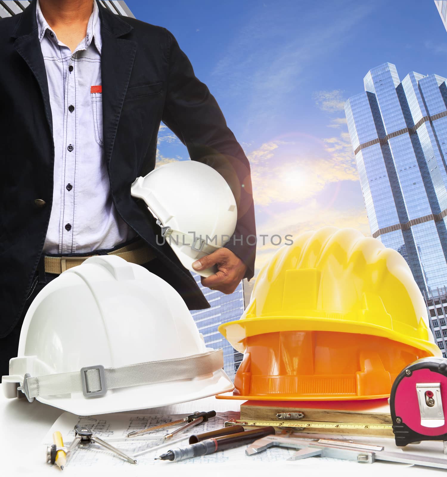 engineer working table against sky scrapper in urban scene use for land development and architecture occupation theme