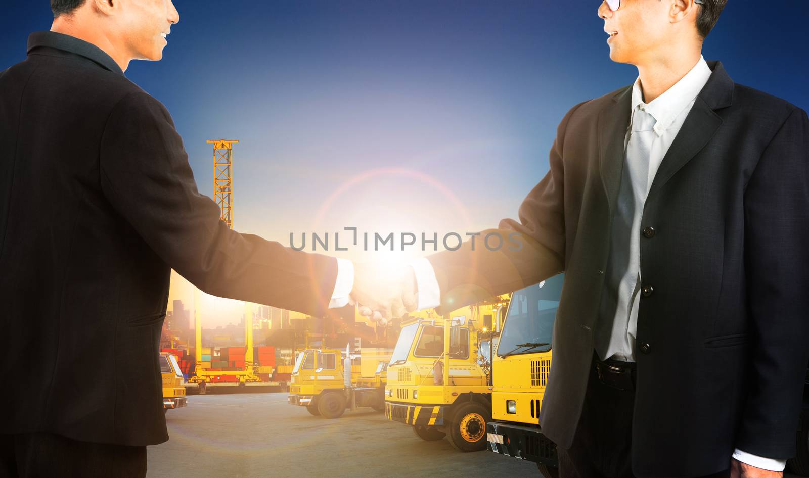 business man shaking hand with successful agriment in container dock and shipping transportation business industry