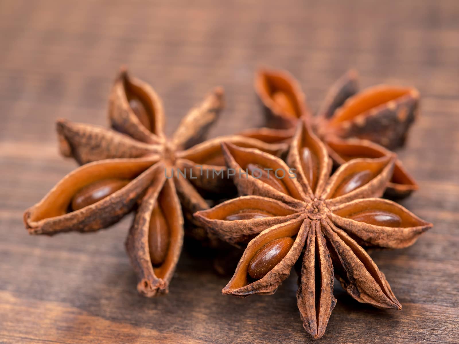 star anise on wooden background close up with copy space