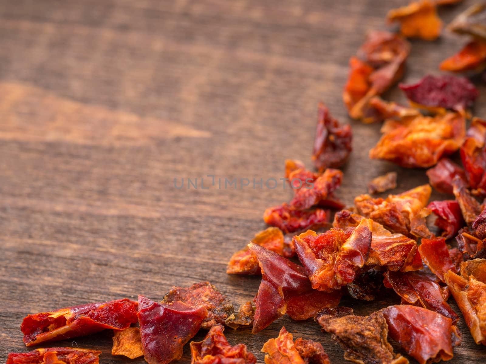 Cayenne pepper or paprika on wooden backround with copy space. Dry red pepper with copyspace