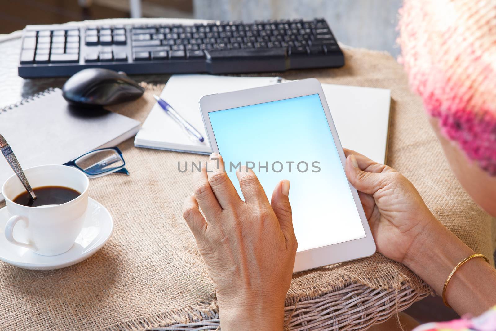 woman and tablet computer in hand sliding on touching screen use for people and lifestyle in digital technology