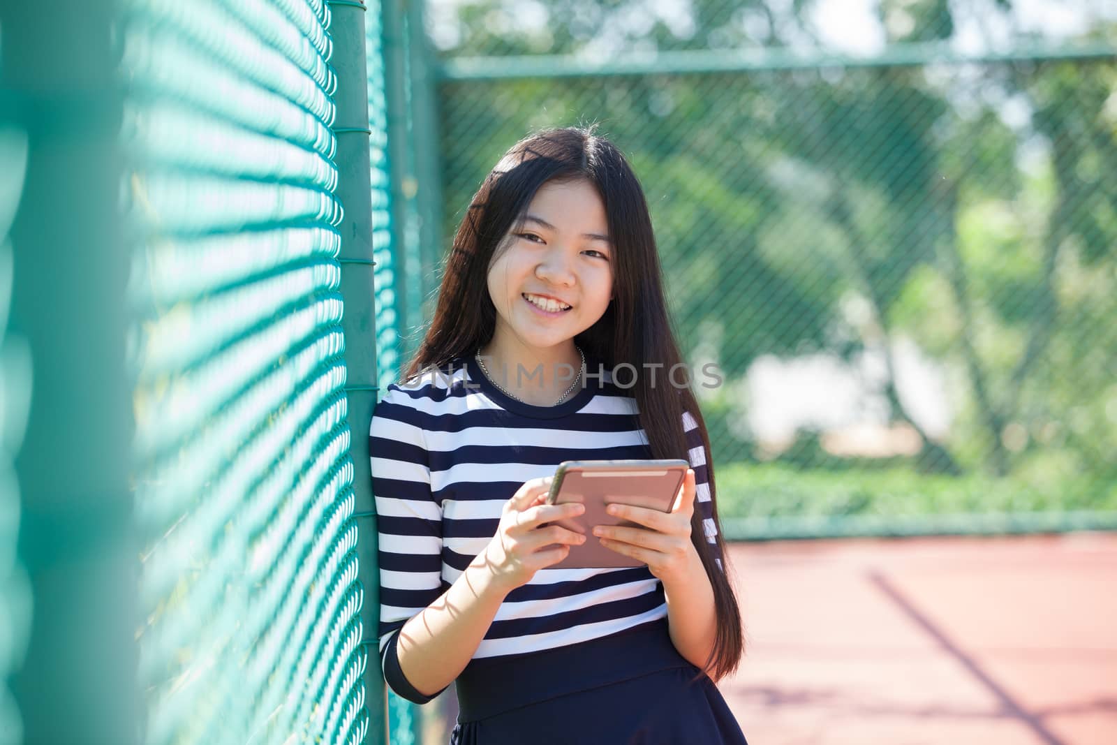 asian girl and computer tablet in hand standing with toothy smiling face use for people and internet connecting ,communication in modern digital lifestyle