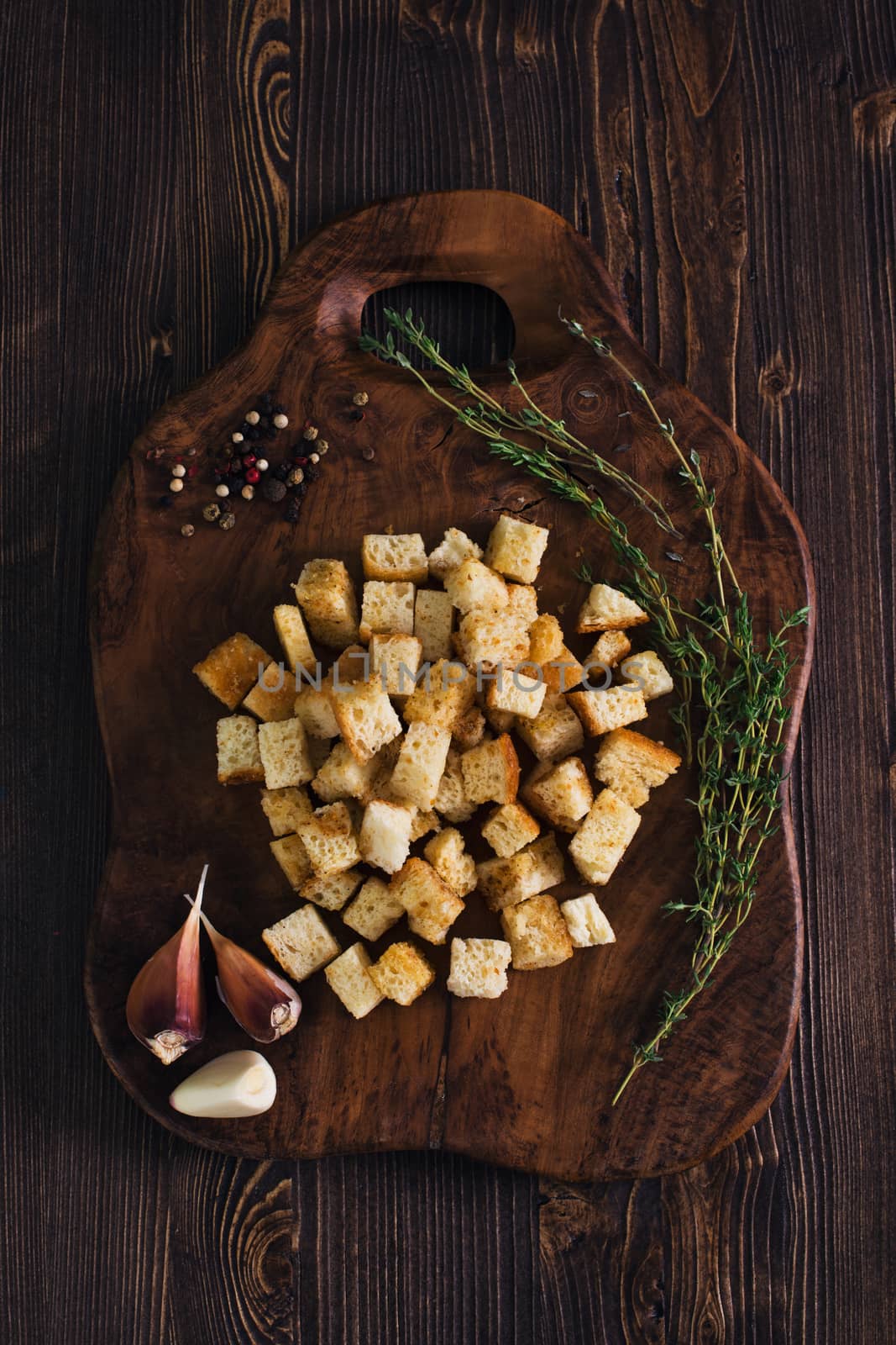 Crackers with herbs and garlic on wooden background