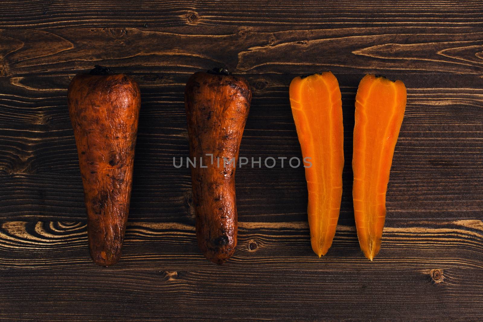 Boiled carrots on dark wooden background