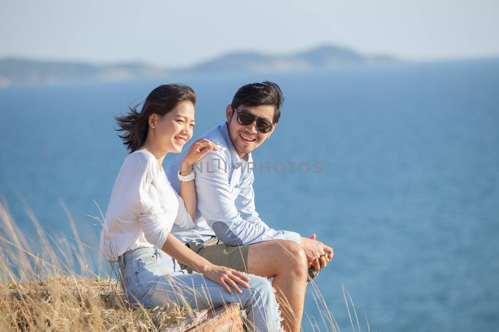 portrait of asian younger man and woman relaxing vacation at sea side happiness emotion