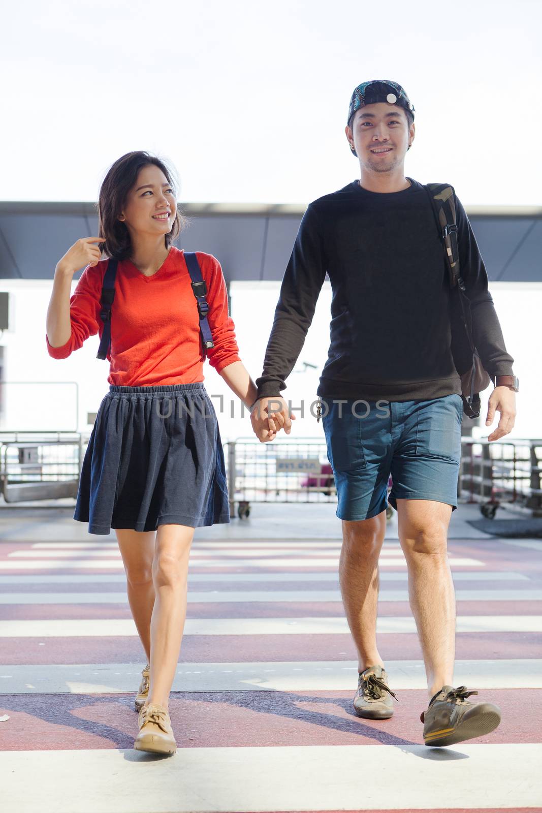 couples asian younger man and woman hand by hand walking with ha by khunaspix
